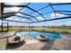 Beautiful screened pool with water feature and brick pavers, overlooking the lake at 5325 San Remo Cir, Wimauma, FL 33598