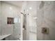Shower interior featuring modern fixtures, a built-in niche, and a glass door at 5325 San Remo Cir, Wimauma, FL 33598
