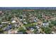 An aerial view showcasing a home nestled in a lush neighborhood with mature trees and city views in the distance at 6213 10Th S Ave, Gulfport, FL 33707