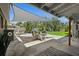 Shaded patio area with outdoor dining set, lounge chairs, and view of the spacious backyard at 6213 10Th S Ave, Gulfport, FL 33707