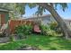 Green backyard retreat with a comfortable egg chair swing, mature trees, and privacy fence at 6213 10Th S Ave, Gulfport, FL 33707
