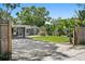Landscaped backyard with a well-maintained lawn, jacuzzi, and covered outdoor lounge area at 6213 10Th S Ave, Gulfport, FL 33707