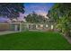 Spacious backyard area featuring a lush green lawn, hot tub, and covered patio with seating at 6213 10Th S Ave, Gulfport, FL 33707
