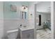 Charming bathroom featuring modern vanity, nautical decor and a glimpse into an adjoining room at 6213 10Th S Ave, Gulfport, FL 33707