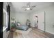 Light-filled bedroom with a patterned chair, desk, and modern lighting fixtures at 6213 10Th S Ave, Gulfport, FL 33707