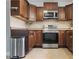 Updated kitchen showcasing stainless steel appliances, tile backsplash, and ample cabinet space at 6213 10Th S Ave, Gulfport, FL 33707
