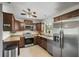 Modern kitchen features stainless steel appliances, wooden cabinets, and tile flooring at 6213 10Th S Ave, Gulfport, FL 33707