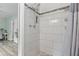 Modern shower with white subway tile, decorative accent stripe, and a pebble tile floor at 6213 10Th S Ave, Gulfport, FL 33707