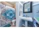 Updated bathroom features bead board walls, a shower, and a pedestal sink with updated lighting and fixtures at 6238 92Nd N Pl # 3201, Pinellas Park, FL 33782