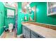 Seafoam green bathroom offers updated lighting and fixtures, decorative vanity, and tiled countertops at 6238 92Nd N Pl # 3201, Pinellas Park, FL 33782