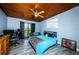 This bedroom features a wood ceiling, gray wood floors, a ceiling fan, and a balcony access point at 6238 92Nd N Pl # 3201, Pinellas Park, FL 33782