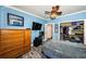 Bedroom with wood-look floors, mounted TV, and closet with shelving at 6238 92Nd N Pl # 3201, Pinellas Park, FL 33782