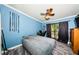 Bedroom with wood-look flooring, ceiling fan, and sliding glass doors to balcony at 6238 92Nd N Pl # 3201, Pinellas Park, FL 33782