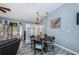 Cozy dining room with stylish pendant lighting, decorative screen and a view of the outdoor deck at 6238 92Nd N Pl # 3201, Pinellas Park, FL 33782