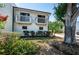 Well-maintained home featuring dual balconies, landscaped beds, mature trees, and manicured lawn at 6238 92Nd N Pl # 3201, Pinellas Park, FL 33782