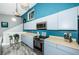 Modern kitchen featuring blue cabinets, stainless steel appliances, and efficient layout at 6238 92Nd N Pl # 3201, Pinellas Park, FL 33782