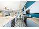 Kitchen and dining area featuring light blue cabinets, a spacious countertop and modern pendant lighting at 6238 92Nd N Pl # 3201, Pinellas Park, FL 33782