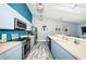Modern kitchen featuring blue cabinets, stainless steel appliances, and stylish countertops at 6238 92Nd N Pl # 3201, Pinellas Park, FL 33782