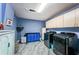 Spacious laundry room with blue cabinetry, modern washer and dryer at 6238 92Nd N Pl # 3201, Pinellas Park, FL 33782