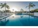 Community swimming pool with lounge chairs and nearby community building at 6238 92Nd N Pl # 3201, Pinellas Park, FL 33782
