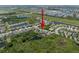 A picture taken from above shows a house in a community, indicated by a red arrow, among ponds and greenery at 6307 Salt Creek Ave, Apollo Beach, FL 33572