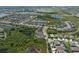Aerial photograph of a community with a well-planned layout, surrounded by trees and ponds at 6307 Salt Creek Ave, Apollo Beach, FL 33572