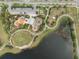 An aerial view of a community park featuring playgrounds, walking trails, and a large pond at 6307 Salt Creek Ave, Apollo Beach, FL 33572