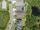 Aerial view of the neighborhood with homes, landscaping, bodies of water, and streets under a bright, cloud-filled sky at 6307 Salt Creek Ave, Apollo Beach, FL 33572