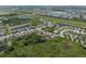 Expansive aerial view of a Primary-planned community with serene ponds and lush green spaces surrounding the neighborhood at 6307 Salt Creek Ave, Apollo Beach, FL 33572