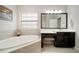 This bathroom features a soaking tub and large vanity with a makeup station at 6307 Salt Creek Ave, Apollo Beach, FL 33572
