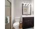Bathroom features a glass-enclosed shower, decorative mirror, and stylish vanity with a dark wood cabinet at 6307 Salt Creek Ave, Apollo Beach, FL 33572