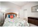 Comfortable bedroom with a queen-size bed, dresser, and a nautical-themed decor at 6307 Salt Creek Ave, Apollo Beach, FL 33572