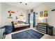 Bright bedroom with Mario-themed decor, blue rug, dark trundle bed and natural light from the window at 6307 Salt Creek Ave, Apollo Beach, FL 33572