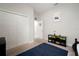 Bedroom features a spacious closet, gray walls, tan carpet, and an entertainment center with colorful containers at 6307 Salt Creek Ave, Apollo Beach, FL 33572