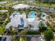 Aerial view of the community clubhouse with a pool, lake, and parking at 6307 Salt Creek Ave, Apollo Beach, FL 33572