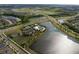 Aerial view showcases a community center with a pool, tennis courts, and playground, surrounded by ponds at 6307 Salt Creek Ave, Apollo Beach, FL 33572
