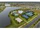 Aerial view showcasing the pool, clubhouse, volleyball court, tennis and basketball courts, and lake at 6307 Salt Creek Ave, Apollo Beach, FL 33572