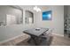 Elegant dining room with modern accents, featuring a decorative centerpiece and ample natural light at 6307 Salt Creek Ave, Apollo Beach, FL 33572