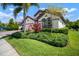 Desirable home boasting manicured landscaping and a paver driveway on a sunny day at 6307 Salt Creek Ave, Apollo Beach, FL 33572