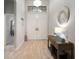 Bright foyer featuring neutral tile flooring, a decorative mirror, and an elegant chandelier at 6307 Salt Creek Ave, Apollo Beach, FL 33572