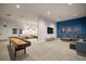 A modern game room featuring a shuffleboard table, comfortable seating and a large screen tv at 6307 Salt Creek Ave, Apollo Beach, FL 33572