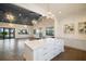 Community clubhouse with a large kitchen island, modern lighting and views of the outdoor pool at 6307 Salt Creek Ave, Apollo Beach, FL 33572