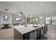 Open concept kitchen with a center island flowing into the dining and living space, perfect for entertaining at 6307 Salt Creek Ave, Apollo Beach, FL 33572
