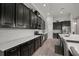 Modern kitchen featuring stainless steel appliances, dark cabinets, beautiful countertops and a beverage cooler at 6307 Salt Creek Ave, Apollo Beach, FL 33572
