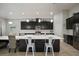 Open kitchen with a large center island, white countertops, and dark cabinetry, ideal for entertaining at 6307 Salt Creek Ave, Apollo Beach, FL 33572