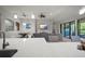 Open-concept living room featuring a granite kitchen island, dining area, and comfortable seating at 6307 Salt Creek Ave, Apollo Beach, FL 33572