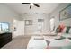 A neutral painted main bedroom, features a ceiling fan and an ensuite bathroom at 6307 Salt Creek Ave, Apollo Beach, FL 33572