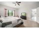 This main bedroom features neutral paint, a ceiling fan, and a wall mounted television at 6307 Salt Creek Ave, Apollo Beach, FL 33572