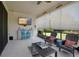 Inviting screened patio featuring comfortable lounge chairs, a ceiling fan, and a TV for entertainment at 6307 Salt Creek Ave, Apollo Beach, FL 33572