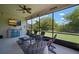 Relaxing screened patio with comfortable seating, a ceiling fan, and a view of the lush backyard at 6307 Salt Creek Ave, Apollo Beach, FL 33572